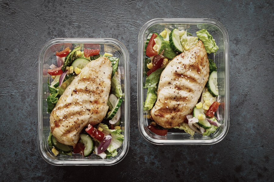 Meal prep containers with chicken and salad
